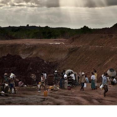 Workers building a water catchment area behind a government-constructed irrigation dam that flooded land belonging to Aung Thay and other villagers from Karen State. 