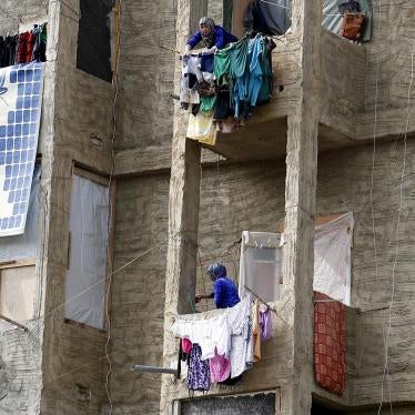Syrian women hang clothing on their balconies inside a compound for Syrian Refugees in Sidon, south Lebanon April 17, 2015. 