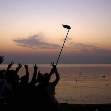 Syrian refugees take "selfies" moments after arriving on an overcrowded dinghy at a beach on the Greek island of Kos.