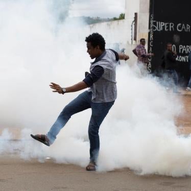 A man reacts to tear gas fired by police fire to disperse rival marches by hundreds of protesters, after mobs looted stores this week believed to belong to immigrants in Pretoria, South Africa, February 24, 2017.
