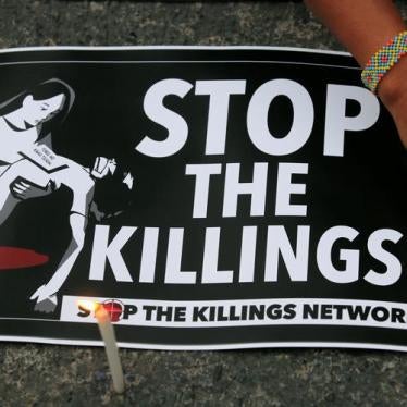 A protester lights candles next to a placard, seeking justice for killings in President Rodrigo Duterte's war on drugs, during a protest in front of the Philippine National Police (PNP) headquarters in Quezon city, Metro Manila, Philippines August 23, 201