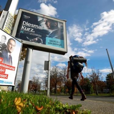 A woman walks past election campaign poster of far right Freedom Party (FPOe) head and top candidate Heinz-Christian Strache and People's Party (OeVP) top candidate and Foreign Minister Sebastian Kurz in Vienna, Austria October 4, 2017.