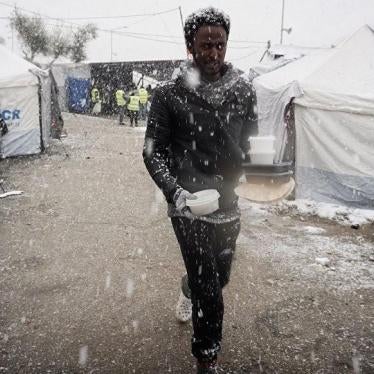 A migrant walks after receiving food during snowfall at the Moria hotspot on the Greek island of Lesbos, on January 9, 2017. 