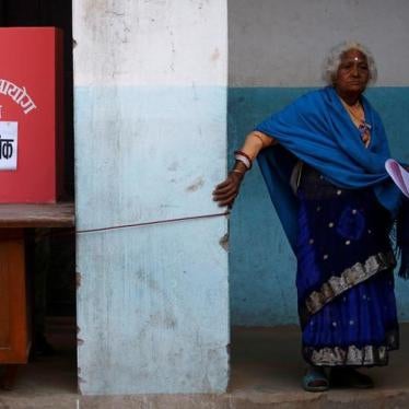 A woman walks to cast her vote during elections in Thimi, Nepal, December 7, 2017.