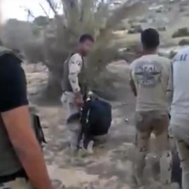 3) A member of a military-backed militia prepares to execute the second detainee. © 2017 Mekameleen