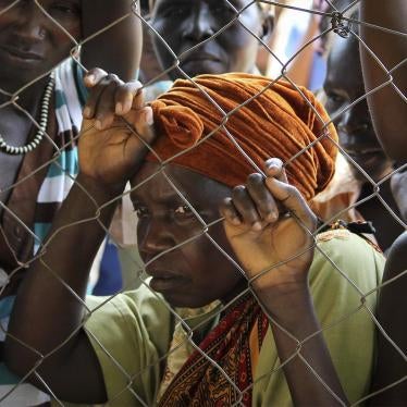Women stand outside a UN Refugee Agency (UNHCR) site in Yei