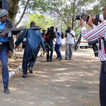 An anti-riot police officer aims a teargas canister while journalists cover an anti-corruption protest in Kenya's capital, Nairobi. November 3, 2016. 