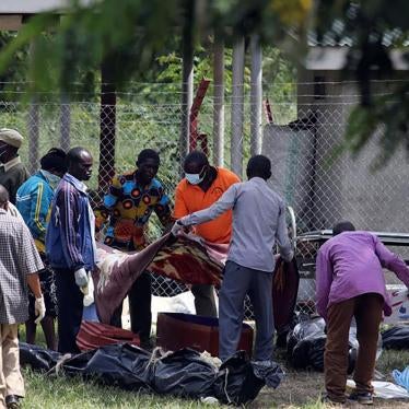 Relatives collect bodies of loved ones who were killed when Uganda security forces stormed the palace of Charles Wesley Mumbere, king of the Rwenzururu, in Kasese town, western Uganda on November 27. 