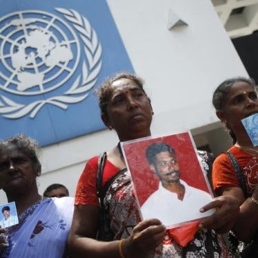 Sri Lankan Tamil women hold up photographs of their missing family members as they wait to hand over a petition to the U.N. head office in Colombo March 13, 2013. 