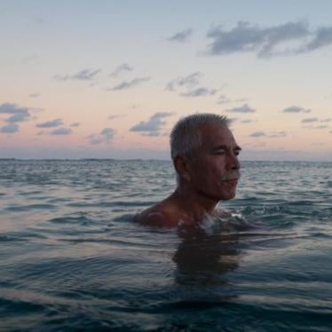 Anote Tong, then president of Kiribati, swims in the lagoon near his home.