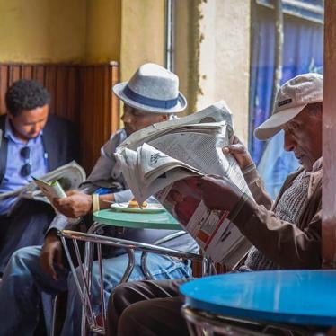 Ethiopian men read newspapers at a cafe during a declared state of emergency in Addis Ababa, Ethiopia. 