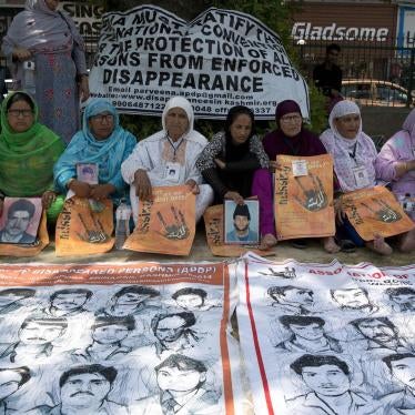 Relatives of disappeared persons participate in a silent protest, demanding an investigation into the disappearances of people in Kashmir. 