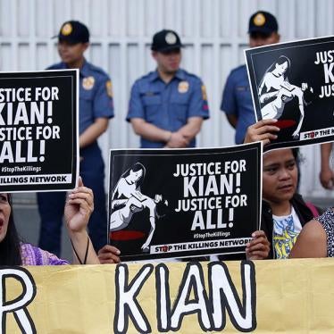 Protesters display placards and shout slogans during a rally outside the Philippine National Police headquarters to protest the killing by police of Kian Loyd Delos Santos, a 17-year-old grade 11 student