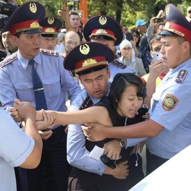 Kazakhstan police officers detain a protester during an opposition rally in Almaty, Kazakhstan.