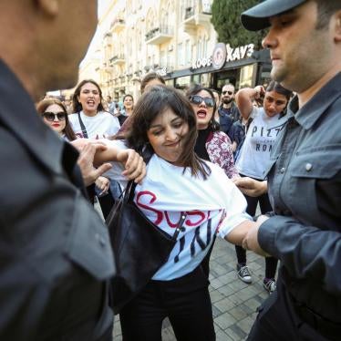 A women’s rights protester is detained by police in Baku on October 20. 