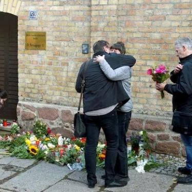 People mourn in front of a synagogue in Halle, Germany, Thursday, Oct. 10, 2019. 