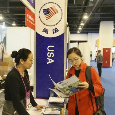 Chinese visitors talk with education consultants at the booth of the United States during an expo in Beijing, China, 20 October 2018.