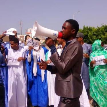 Students protesting against a discriminatory government decision limiting enrollment in public university to 24 years, hold up signs that say “education is a right for all.”