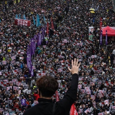 A protestor shows five demands gesture as Hong Kong people participate in their annual pro-democracy march in Hong Kong, January 1, 2020. 