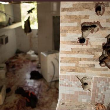 Bullet holes in the wall and blood on the floor of a house in the Fallet neighborhood in Rio de Janeiro after police killed nine men there on February 8, 2019.