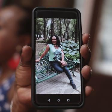 A transgender woman shows a photograph of Camila Díaz, whom she met while migrating to the US, where they both turned themselves in to immigration authorities. Both women were eventually deported.