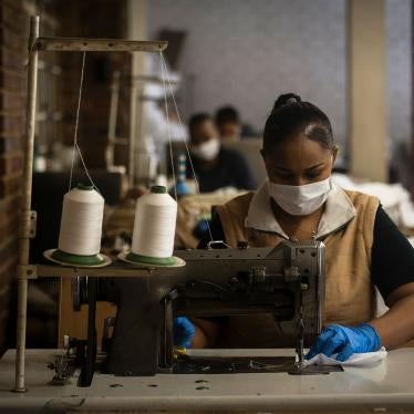 A woman sews face masks at a furniture factory in Eldorado Park, Johannesburg, Tuesday, March 24, 2020,